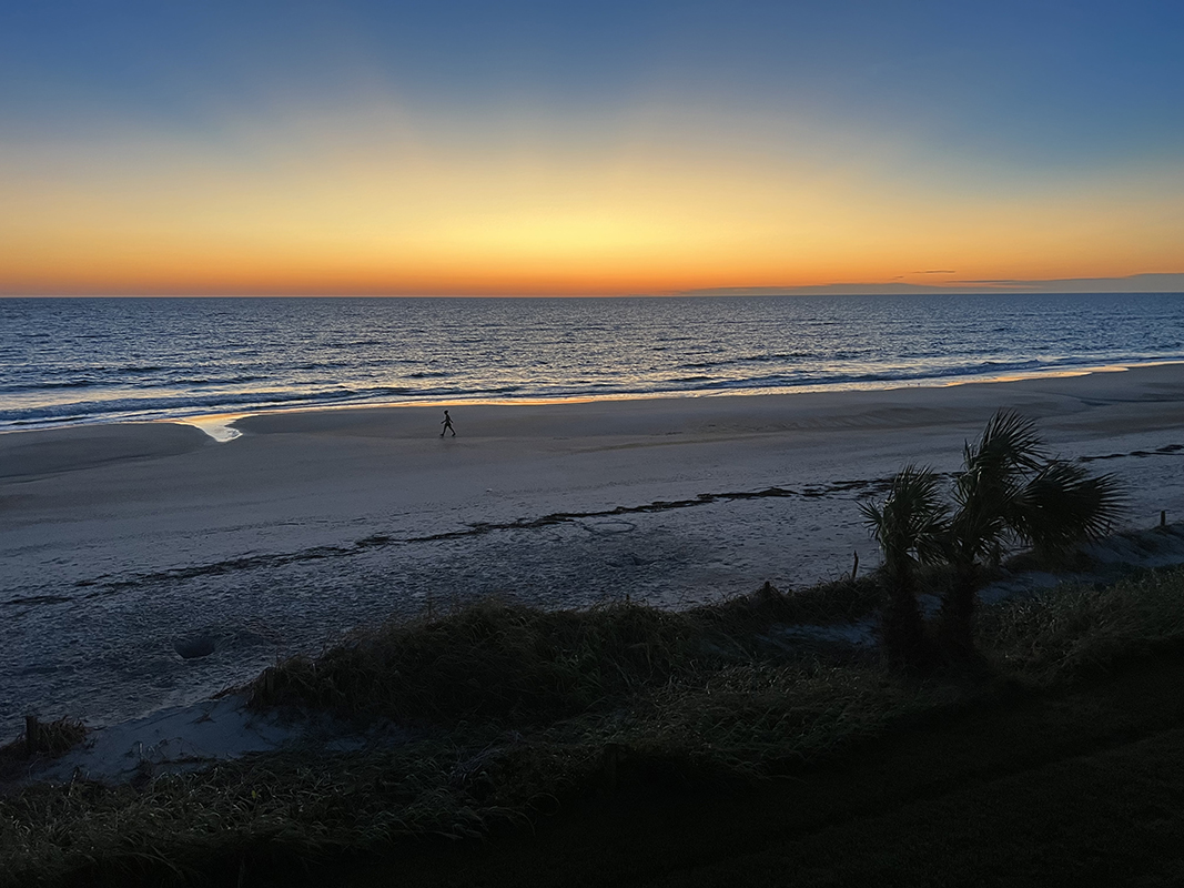 Rays of the sun spread into the blue sky at sunrise