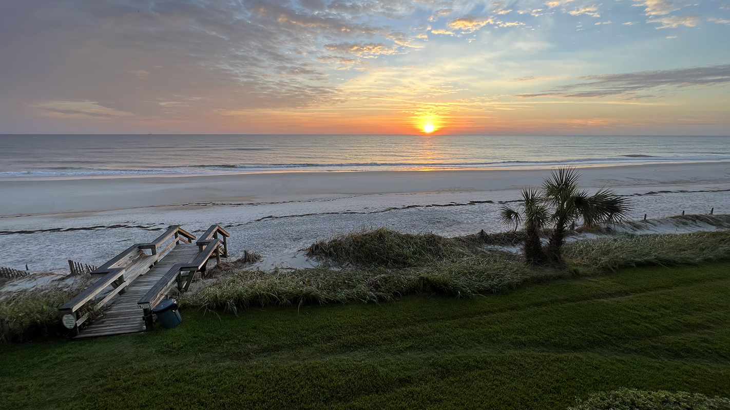 Sunrise over the ocean with clouds to the left
